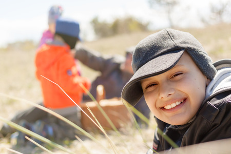 children picnic happy smile outdoor close up lying on the grass shallow DOFの写真素材