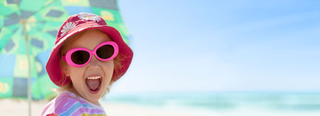 child girl happy smile healthy teeth sun glasses beach summer vacations panoramaの写真素材