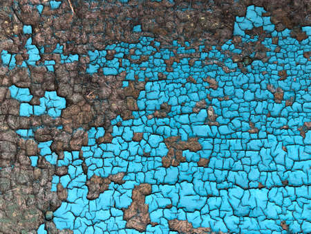 Blue Wooden Background. A weathered close-up of cracked paint on a wooden board is like a creatively designed textured background painting. Wood textureの写真素材