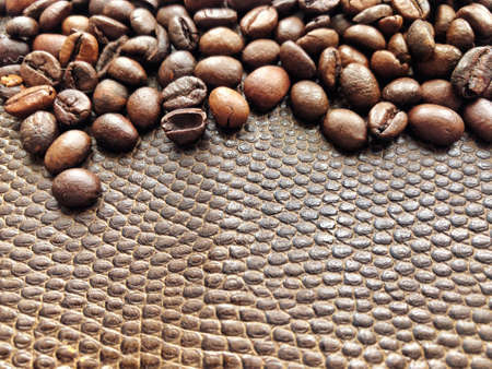 Coffee beans texture. Top view roasted coffee beans on brown leather.の写真素材