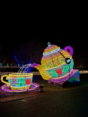 29.12.2025, Poland, Warsaw, Glowing teapot and cup at Garden of Lights winter festival.