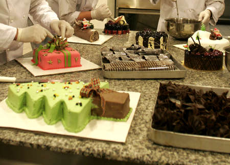 Pastry chef preparing a cake in the kitchen of a confectionery