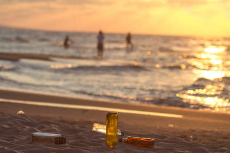 Bottles of beer on the beach at sunset. Selective focus.の写真素材