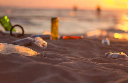 Plastic waste on the beach at sunset. Environmental pollution concept.の写真素材