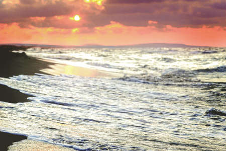 Sunset on the beach of the Baltic Sea in Kolobrzeg, Poland