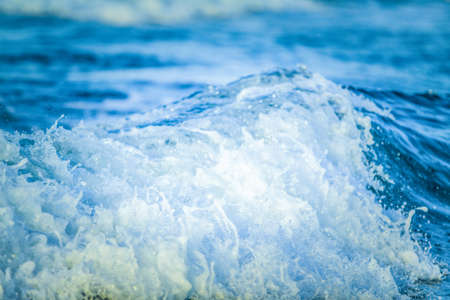 Close-up of sea wave breaking on the shore. Natural backgroundの写真素材