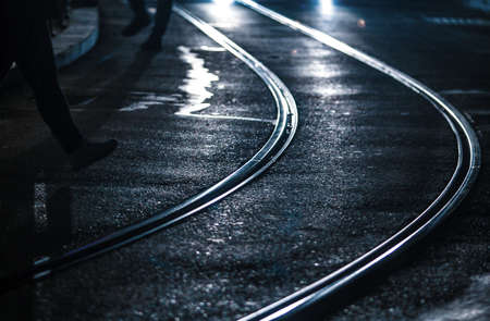 Tram tracks in the city at night, close-up.の写真素材