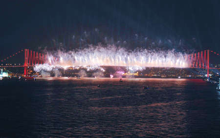The 25th of April Bridge in Lisbon, Portugal. Fireworks over the Tagus river.