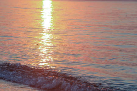 Sunset on the sea. The sun is reflected in the water.の写真素材