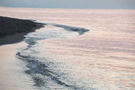 Baltic sea shore at sunset. Waves, splashes, foam. Idyllic seascape. Nature, environment, ecology, climate change, fickle weatherの写真素材