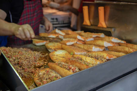 Bread with meat and vegetables on the street food festival in Thailandの写真素材