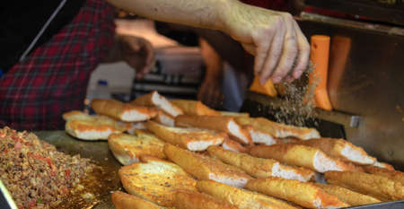 Bread with minced meat on a street food stall. Street food concept.の写真素材