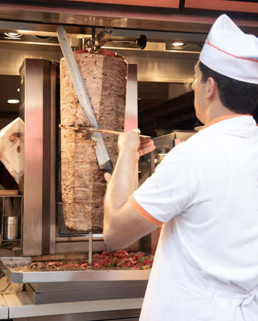A professional chef prepares a dish in a restaurant kitchen.の写真素材