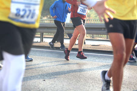 Marathon running race, people feet on city road, healthy lifestyleの写真素材
