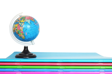 Notebooks and globe isolated on white backgroundの写真素材