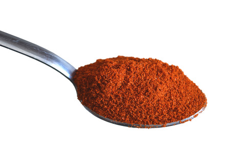 A spoon of grounded pepper isolated on white backgroundの写真素材