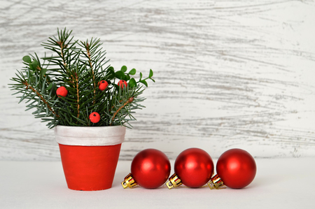 Three red Christmas balls and natural Christmas arrangementの写真素材