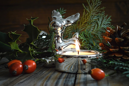 Merry Christmas: Christmas reindeer and natural decoration on wooden backgroundの写真素材