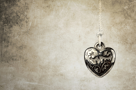 Heart pendant on grunge backgroundの写真素材