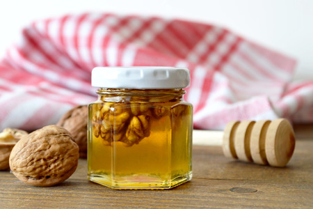 Honey  and walnuts on wooden backgroundの写真素材