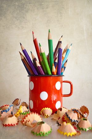 Coloring pencils in old mug on grunge backgroundの写真素材