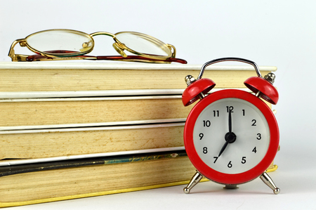 Books, glasses and alarm clockの写真素材