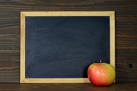 Empty blackboard and an appleの写真素材