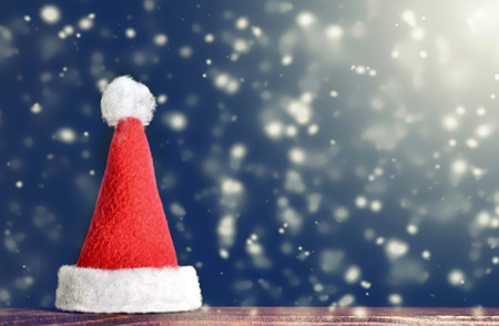 Christmas card: Santa hat and snowy background