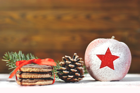 Merry Christmas: Christmas apple, cookies and pineconeの写真素材