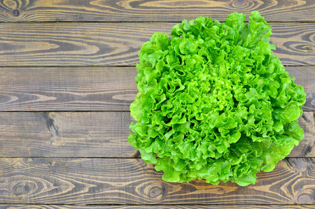 Top view of fresh lettuce on wooden backgroundの写真素材