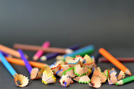 Back to school: Colored pencils and pencil shavings on dark backgroundの写真素材