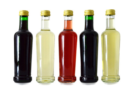 White, rose, and red wine bottles  isolated on white backgroundの写真素材