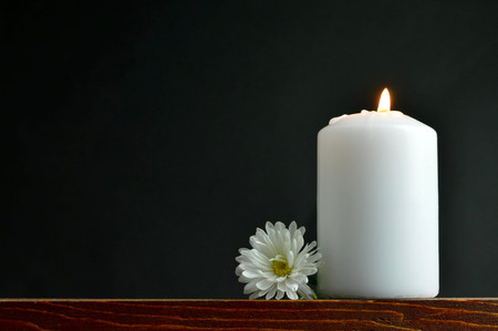 Burning candle and white flowerの写真素材