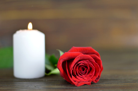 Candle and rose on wooden backgroundの写真素材