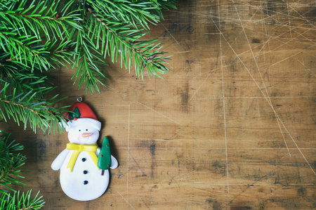 Christmas  background with Snowman and christmas tree branchesの写真素材
