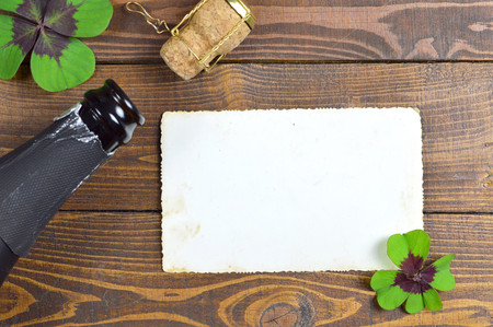 New Year card with champagne cork and lucky cloverの写真素材