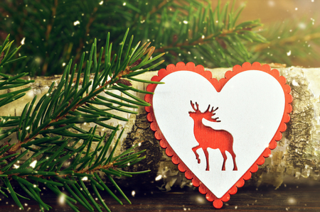Christmas card with wooden heart ornamentの写真素材