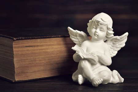 Angel guardian reading a book