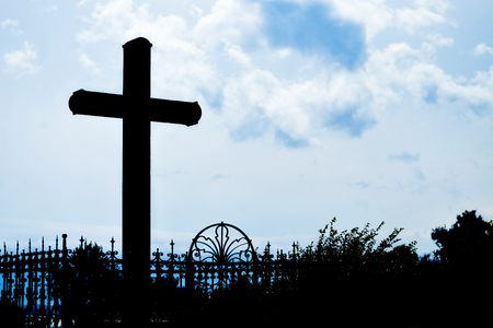 Cross silhouette against blue skyの写真素材