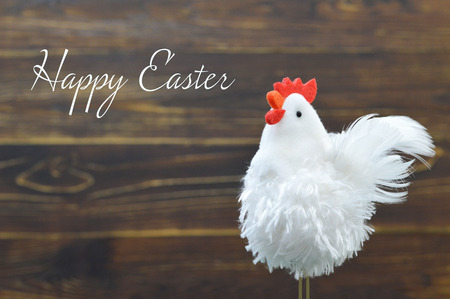 Happy Easter card with rooster toy on wooden backgroundの写真素材