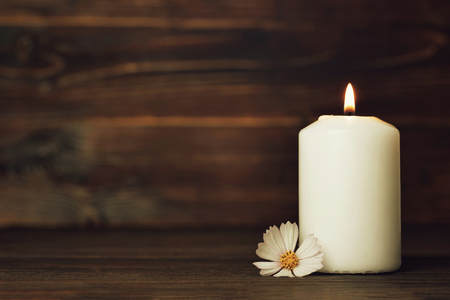 Condolence card with white burning candle and flowerの写真素材