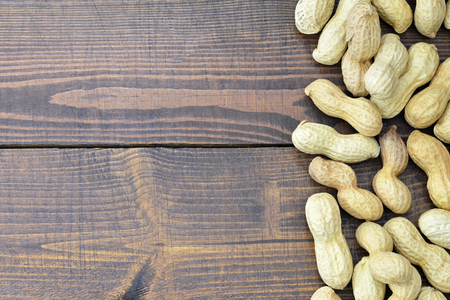 Peanuts on wooden background