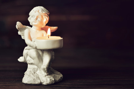 Condolence card with an angel holding a burning candleの写真素材