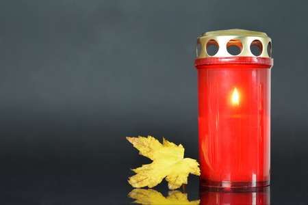 All Soul's Day. Memorial candle and autumn leafの写真素材