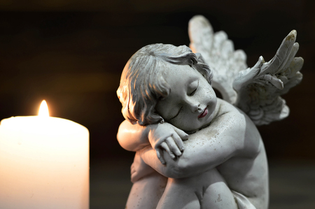 Angel and burning candleの写真素材