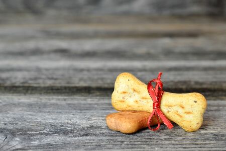 Dog biscuits on wooden background