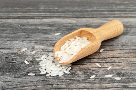 White rice in wooden scoopの写真素材