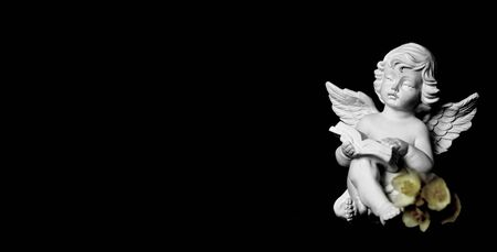 Condolence card with guardian angel on black backgroundの写真素材