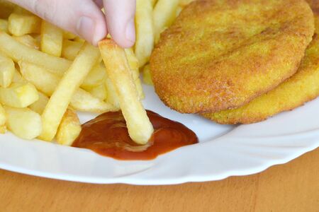 Fish and chips with ketchup. French fries and fish with ketchup