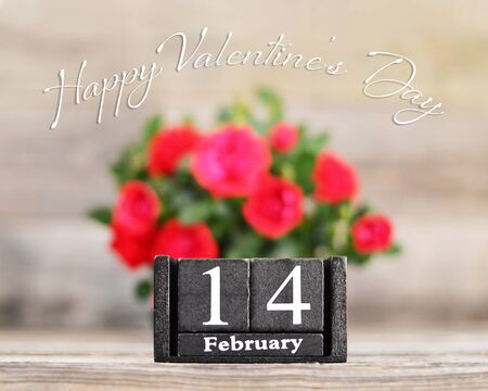 Happy Valentines Day card with red roses and wooden retro calendarの写真素材